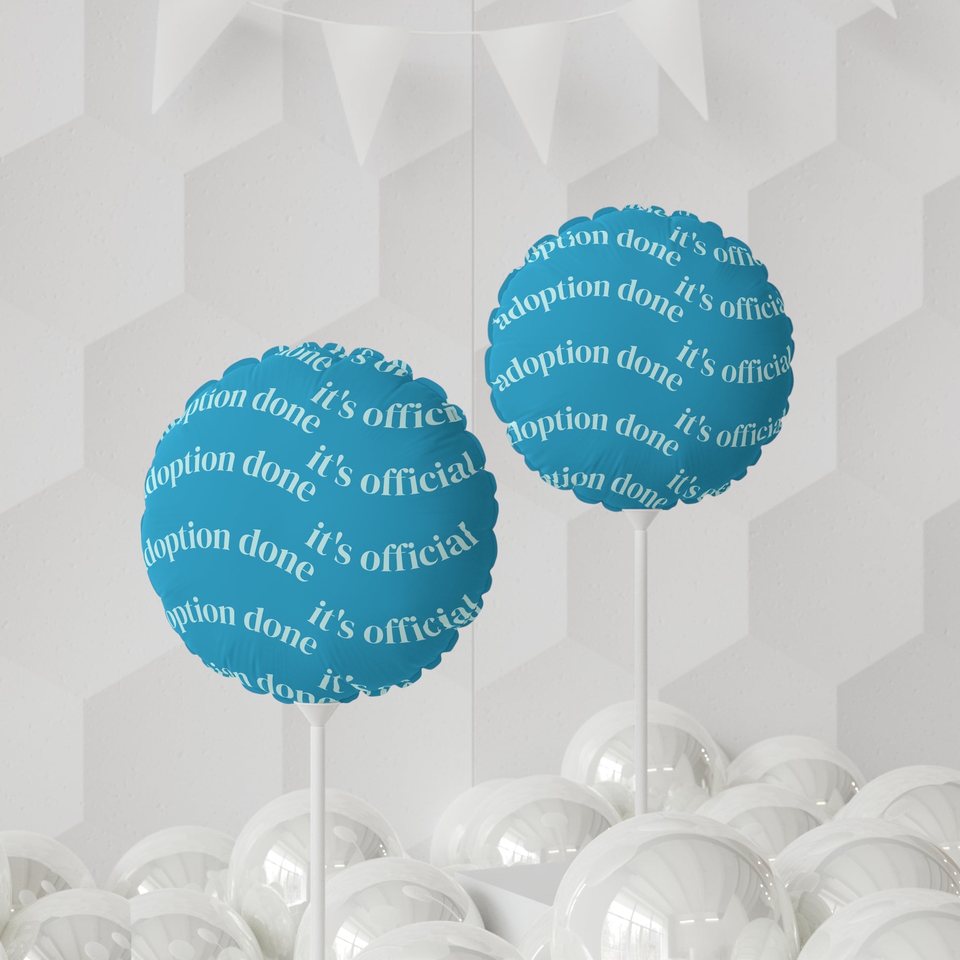 Blue balloons with 'adoption done, it's official!' text on a white background